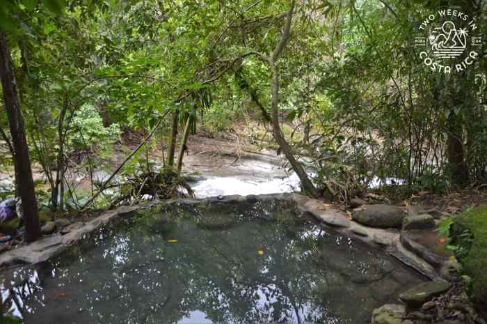 view of the river below from a natural hot spring pool