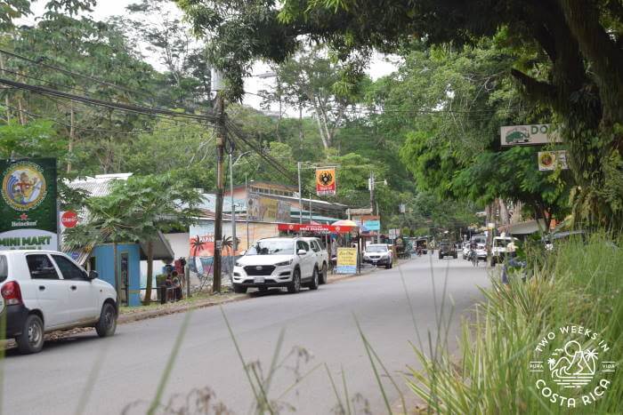main road in Dominical with some businesses and parked cars