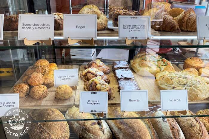 A bakery display case with breads and pastries 