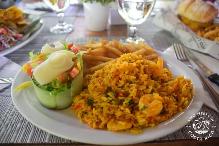 Rice dish with orange color and side salad