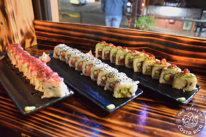 Three different sushi rolls plated on a table